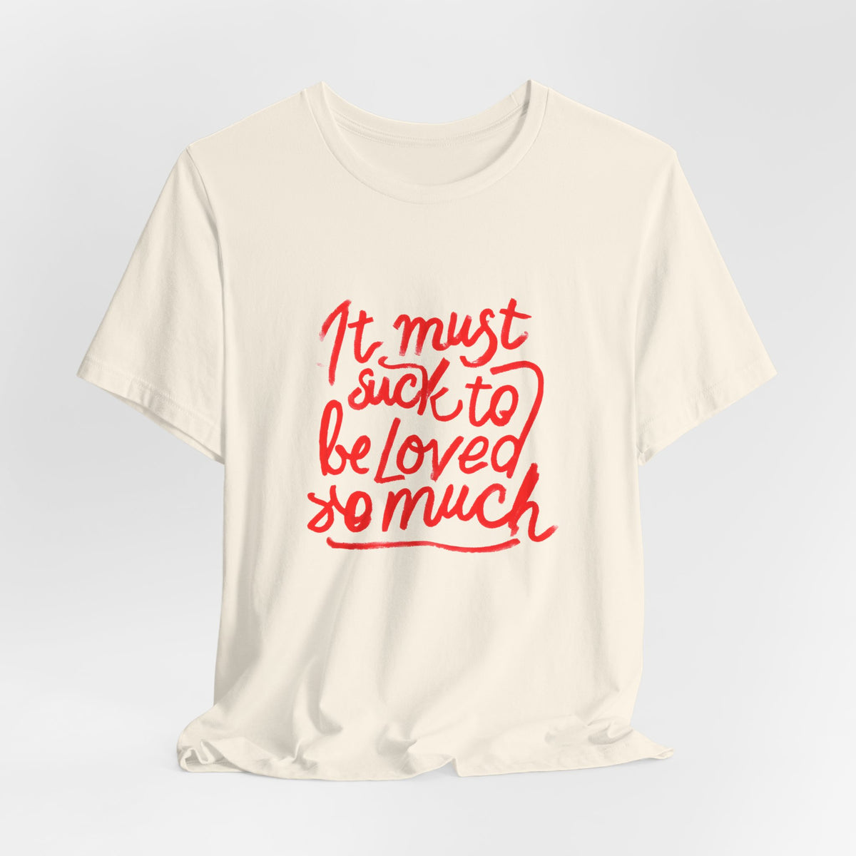 T‑Shirt — “It Must Suck to Be Loved So Much” Red Script Tee