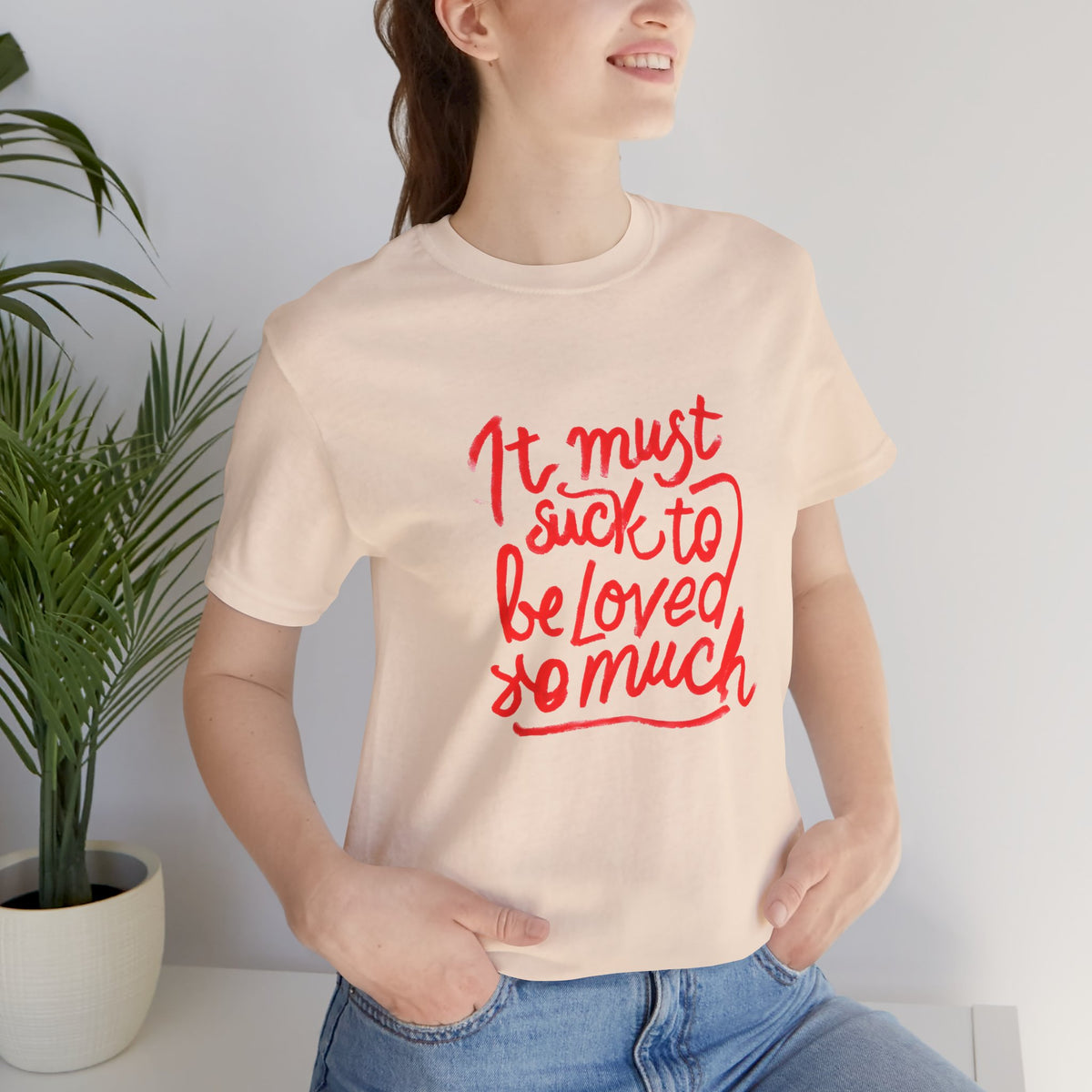 T‑Shirt — “It Must Suck to Be Loved So Much” Red Script Tee
