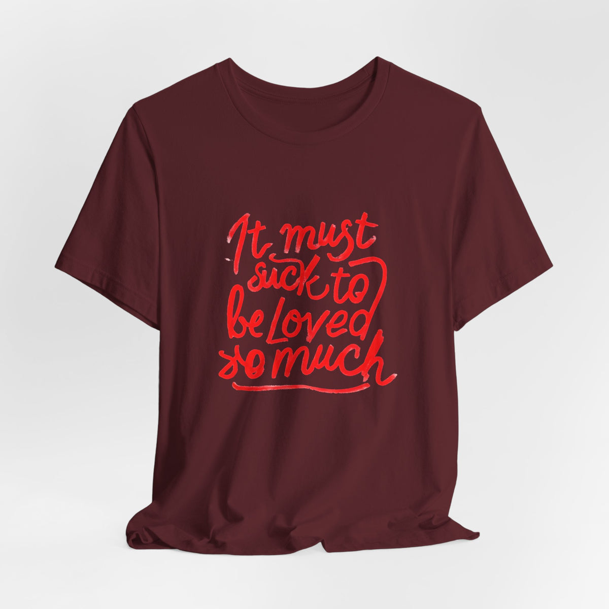 T‑Shirt — “It Must Suck to Be Loved So Much” Red Script Tee