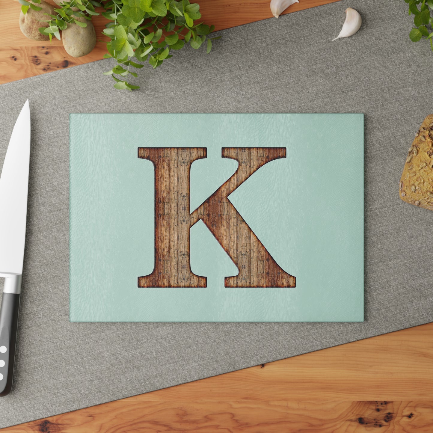 Monogram 'K' Glass Cutting Board — Rustic Wood Letter on Mint Background