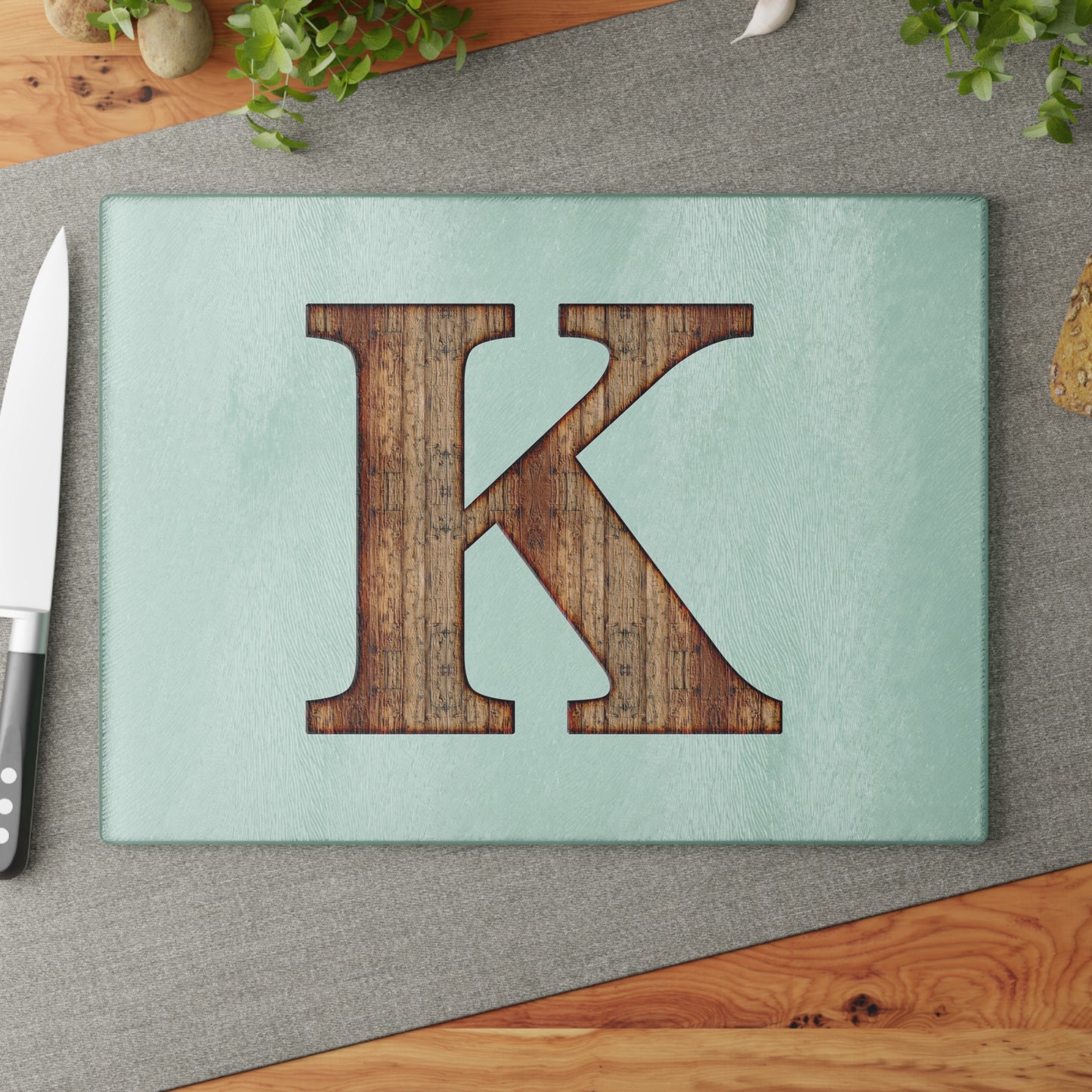 Monogram 'K' Glass Cutting Board — Rustic Wood Letter on Mint Background