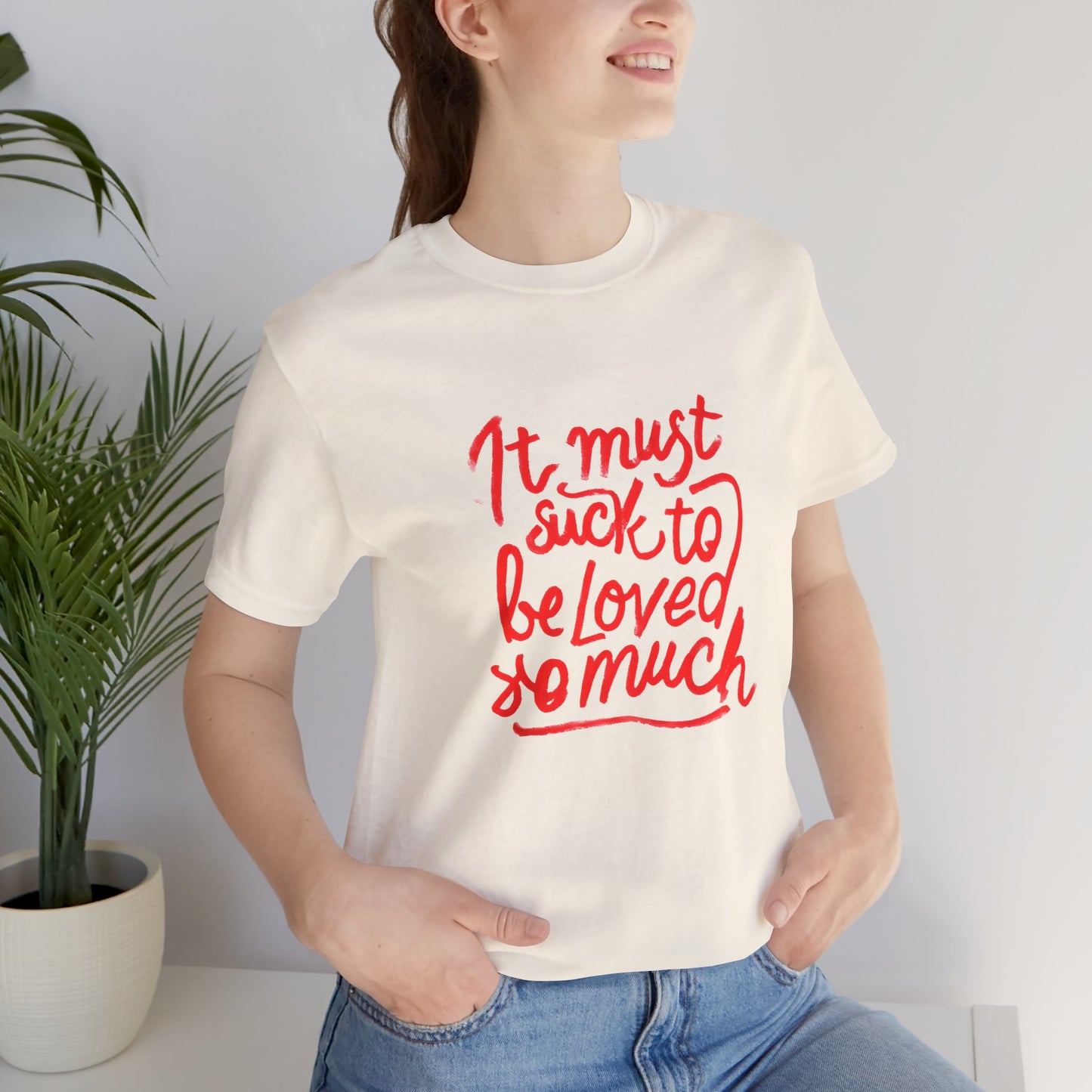 T‑Shirt — “It Must Suck to Be Loved So Much” Red Script Tee