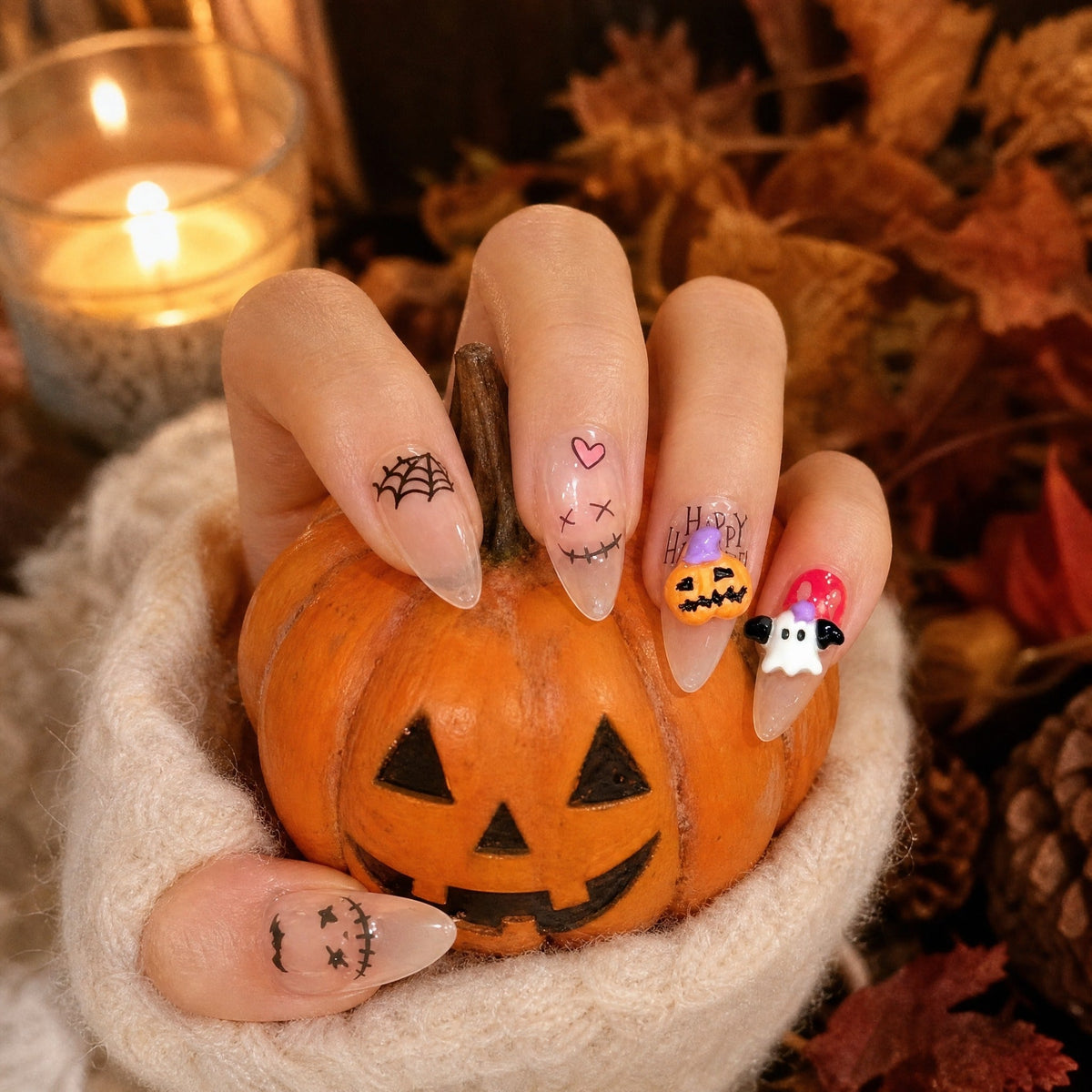 Halloween ghost pumpkin web stiletto press on nails in a Halloween scene with a carved pumpkin