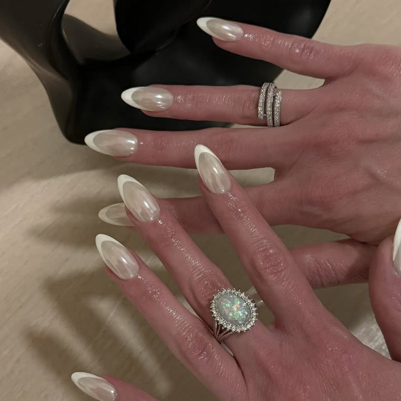 Classic french white press-on nails with white trim, glitter coating, and sparkling nail art