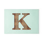 Monogram 'K' Glass Cutting Board — Rustic Wood Letter on Mint Background